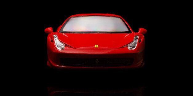 Krivoy Rog, Ukraine - August 22, 2014: Toy ferrari 458 Italia on black backgrond. The photo is made in a studio. Editorial Use Only.