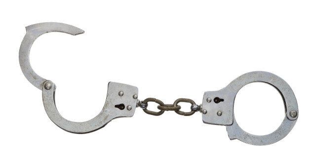 A set of handcuffs, isolated on white.