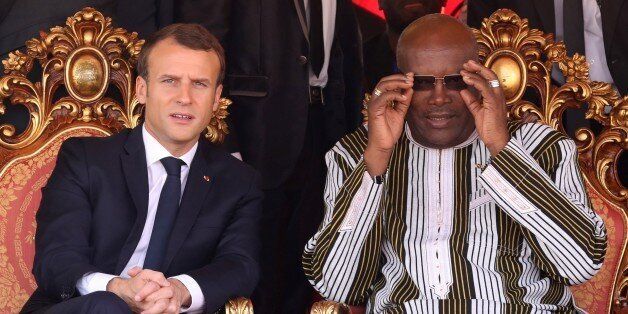 French president Emmanuel Macron (L) speaks with Burkina Faso's President Roch Marc Christian Kabore attend the inauguration ceremony of the solar energy power plant in Zaktubi, near Ouagadougou, on november 29, 2017, on the second day of his first African tour since taking office. / AFP PHOTO / POOL / LUDOVIC MARIN        (Photo credit should read LUDOVIC MARIN/AFP/Getty Images)