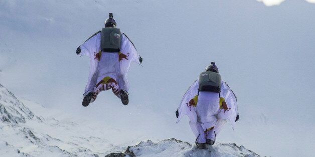 LAUTERBACH, SWITZERLAND - OCTOBER 13: In this handout image provided by Red Bull, wingsuit flyers Fred Fugen and Vince Reffet, known as the Soul Flyers, catching up and fly into a Pilatus Porter plane, piloted by Philippe Bouvier, in mid air after jumping off the Jungfrau mountain on October 13, 2017 in Lauterbach, Switzerland. After B.A.S.E. jumping from the 4,158 meters high mountain the French athletes had 2.45 minutes and a free fall distance of 3,200 meters to complete their project 'Door I