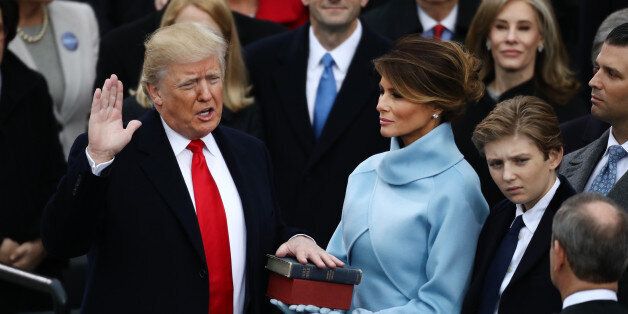 U.S. President-elect Donald Trump takes the oath of office as First Lady-elect Melania Trump stands during the 58th presidential inauguration in Washington, D.C., U.S., on Friday, Jan. 20, 2017. Donald Trump will become the 45th president of the United States today, in a celebration of American unity for a country that is anything but unified. Photographer: Andrew Harrer/Bloomberg via Getty Images