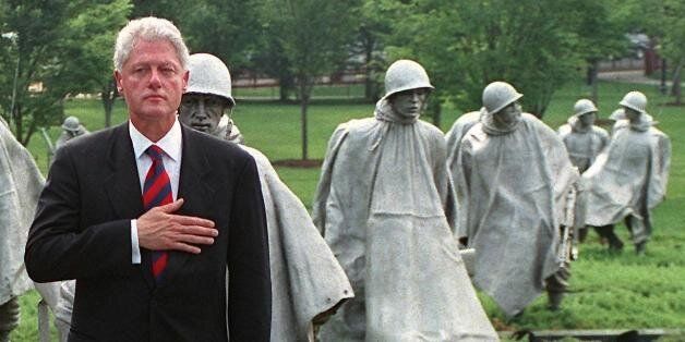 WASHINGTON, DC - JUNE 25:  US President Bill Clinton (R) and South Korean ambassador to the US Hong-Koo Lee (L) hold their hands to their hearts during a commemorative ceremony at the Korean War Memorial 25 June 2000 in Washington, DC.  On the 50th anniversary of the start of the conflict,  Clinton hailed the 'forgotten' US soldiers of the Korean War, praising their 'indispensible' stand for freedom in the decisive early days of the Cold War.  (Photo credit should read GEORGE BRIDGES/AFP/Getty I