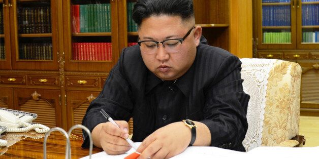 North Korean Leader Kim Jong Un signs the order to carry out the test-fire of inter-continental ballistic rocket Hwasong-14 in this undated photo released by North Korea's Korean Central News Agency (KCNA) in Pyongyang, July, 4 2017. KCNA/via REUTERS ATTENTION EDITORS - THIS IMAGE WAS PROVIDED BY A THIRD PARTY. REUTERS IS UNABLE TO INDEPENDENTLY VERIFY THIS IMAGE. NO THIRD PARTY SALES. SOUTH KOREA OUT.     TPX IMAGES OF THE DAY