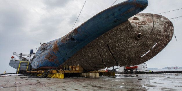 The sunken ferry Sewol on a semi-submersible transport vessel is seen during the salvage operation in waters off Jindo, South Korea. Salvage crews towed the corroded 6,800-ton South Korean ferry and loaded it onto a semi-submersible transport vessel Saturday, completing what was seen as the most difficult part of the massive effort to bring the ship back to shore nearly three years after it sank.  / KOREAN MINISTRY OF OCEANS AND FISHERIES