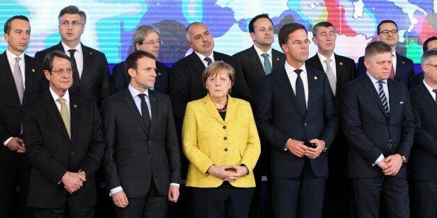 BRUSSELS, BELGIUM - DECEMBER 14: German Federal Chancellor Angela Merkel (front C), Greek Cypriot leader Nikos Anastasiadis (front L), French President Emmanuel Macron (front 2nd L) and  Dutch Prime Minister Mark Rutte (front 2nd R), other officials and the Commanders of Defense Permanent Structured Cooperation (PESCO) gather to pose for a family photo after the first session of the European Summit of the Heads of State and Government of the European Union in Brussels, Belgium on December 14, 20