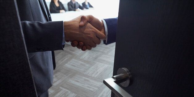 Handshake in office meeting room