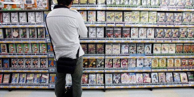 A man looks at video games at a shop in Tokyo's Akihabara district June 9, 2008. REUTERS/Yuriko Nakao (JAPAN)