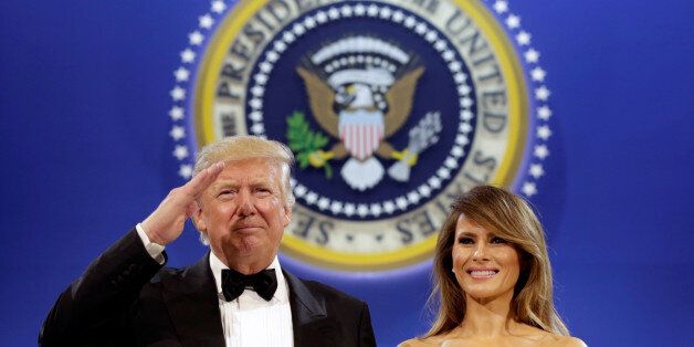 U.S. President Donald Trump salutes with his wife Melania at the Armed Services Ball in Washington, U.S., January 20, 2017. REUTERS/Yuri Gripas