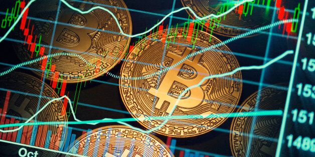 shiny bitcoins with stock market background.