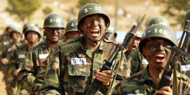South Korean army recruits march during a basic training exercise atthe Army Training Center in Nonsan, 200km (125 miles) south of Seoul,March 18, 2003. South Korean President Roh Moo-hyun said on Tuesday hiscountry must maintain