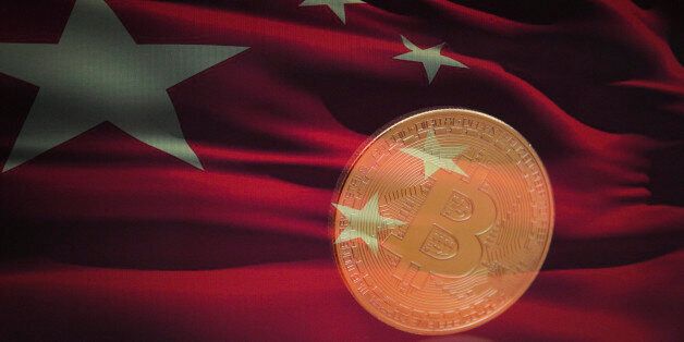 A bitcoin is seen with a Chinese flag in this photo illustration on November 4, 2017. (Photo by Jaap Arriens/NurPhoto via Getty Images)