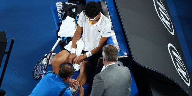 MELBOURNE, AUSTRALIA - JANUARY 26:  Hyeon Chung of South Korea receives medical attention for a blistered foot in his semi-final match against Roger Federer of Switzerland on day 12 of the 2018 Australian Open at Melbourne Park on January 26, 2018 in Melbourne, Australia.  (Photo by Clive Brunskill/Getty Images)