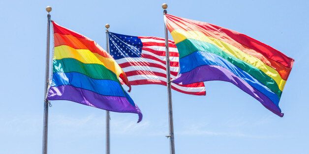 Two Rainbow Flags and a American Flag flying