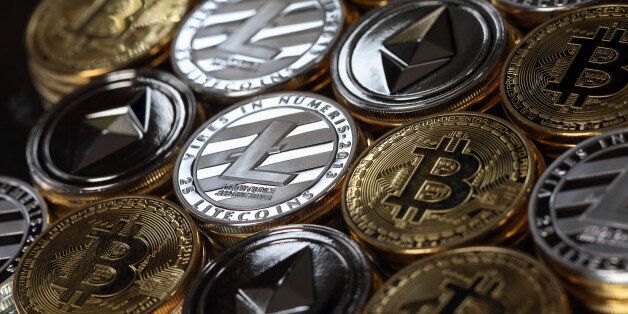 A collection of bitcoin, litecoin and ethereum tokens sit in this arranged photograph in Danbury, U.K., on Tuesday, Oct. 17, 2017. On Wednesday, billionaireÂ Warren BuffettÂ said on CNBC that most digital coins won't hold their value. Photographer: Chris Ratcliffe/Bloomberg via Getty Images