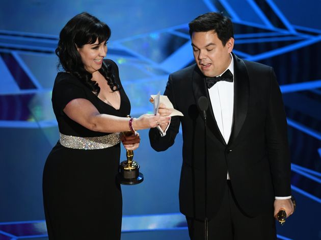 Songwriters Kristen Anderson-Lopez (L) and Robert Lopez accept Best Original Song for 'Remember Me' from 'Coco' onstage during the 90th Annual Academy Awards