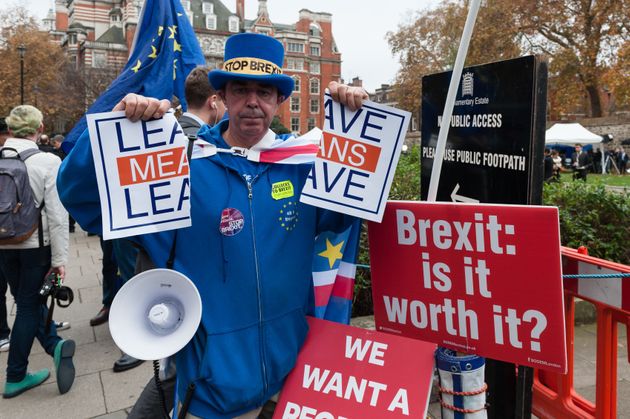 EU 잔류를 지지하는 한 시민이 의사당 바깥에서 시위를 벌이는 모습. 강경 브렉시트 진영의 캠페인 구호(Leave Means Leave)를 찢어버리고 있다. 2018년 11월15일.