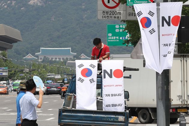 6일 오전 서울 중구 세종대로 일대에서 중구청 관계자들이 태극기와 '노 재팬' 배너깃발을 설치하고 있다. 