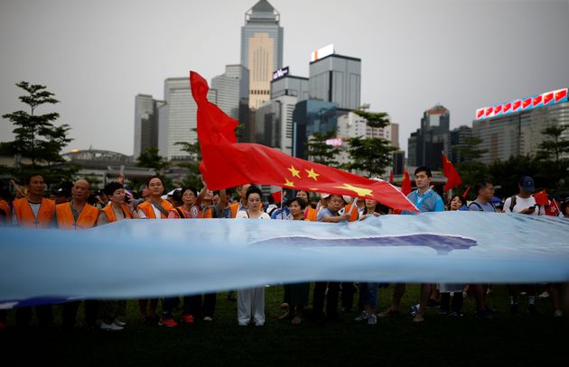 빅토리아항 인근 타마르공원에서 열린 친-중국 시위 '홍콩을 보호하라'에서 참가자들이 중국 국기를 들고 행진하고 있다. 홍콩. 2019년 8월17일.