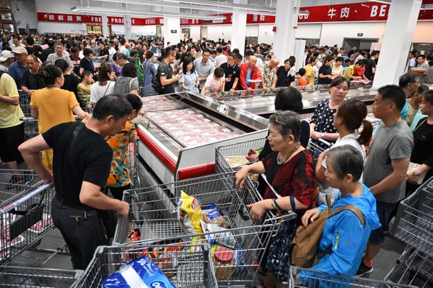 People visit the first Costco outlet in China, on the stores opening day in Shanghai on August 27, 2019. - China has proved a brutal battleground for overseas food retailers in recent years, with many failing to understand consumer habits and tastes as well as local competitors building a stronger presence. (Photo by HECTOR RETAMAL / AFP)        (Photo credit should read HECTOR RETAMAL/AFP/Getty Images)
