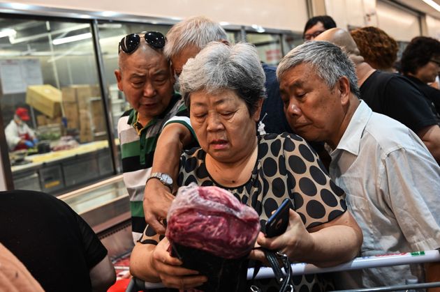 People visit the first Costco outlet in China, on the stores opening day in Shanghai on August 27, 2019. - China has proved a brutal battleground for overseas food retailers in recent years, with many failing to understand consumer habits and tastes as well as local competitors building a stronger presence. (Photo by HECTOR RETAMAL / AFP)        (Photo credit should read HECTOR RETAMAL/AFP/Getty Images)