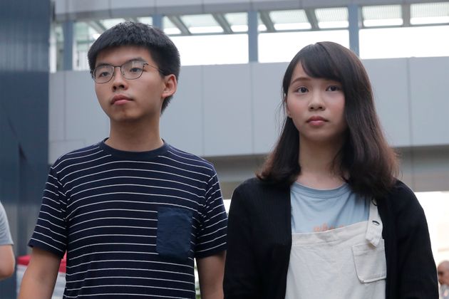 In this June 18, 2019, photo, pro-democracy activists Agnes Chow, right, and Joshua Wong meet media outside government office in Hong Kong. Demosisto, a pro-democracy group in Hong Kong posted on its social media accounts that well-known activist Joshua Wong had been pushed into a private car around 7:30 a.m. Friday, Aug. 30, 2019 and was taken to police headquarters. It later said another member, Agnes Chow, had been arrested as well. (AP Photo/Kin Cheung)