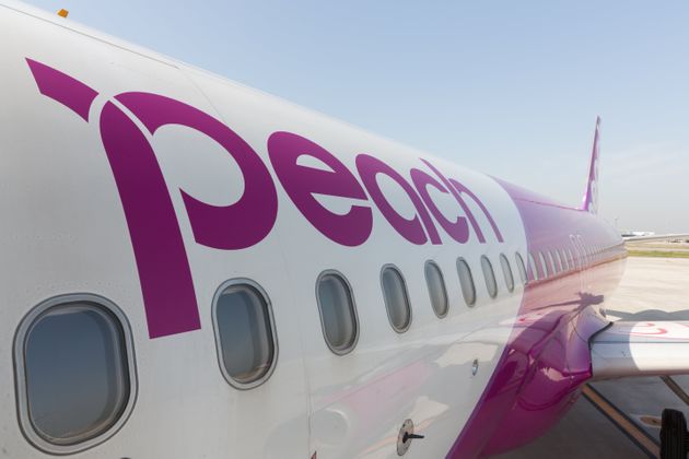 Osaka, Japan - April 18, 2015: Peach Aviation Airbus A320 at Kansai International Airport in Osaka, Japan. It is a low-cost airline based in Japan.