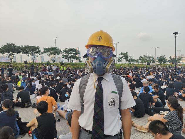 HONG KONG, CHINA - AUGUST 22: A high-school student, wearing a helmet and a face-mask, is seen at a rally in Hong Kong, China on August 22, 2019. Large-scale protests in Hong Kong began last June against a bill to legalize the extradition of suspects to mainland China, Macao and Taiwan. (Photo by Fuat Kabakci/Anadolu Agency via Getty Images)