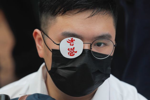 A secondary student covers one eye reading 'Hong Kong' in memory of a woman injured in an earlier pro-democracy protest in Hong Kong, on Monday, Sept. 2, 2019. Hong Kong has been the scene of tense anti-government protests for nearly three months. The demonstrations began in response to a proposed extradition law and have expanded to include other grievances and demands for democracy in the semiautonomous Chinese territory. (AP Photo/Kin Cheung)