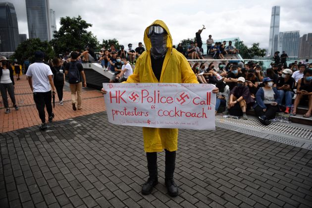 TOPSHOT - A protester holds a sign during a rally at Tamar Park in Hong Kong on September 2, 2019, in the latest opposition to a planned extradition law that has since morphed into a wider call for democratic rights in the semi-autonomous city. - Thousands of black-clad students rallied on September 2 at the start of a two-week boycott of university classes, piling pressure on Hong Kong's leaders to resolve months of increasingly violent anti-government protests that show no sign of easing. (Photo by Lillian SUWANRUMPHA / AFP)        (Photo credit should read LILLIAN SUWANRUMPHA/AFP/Getty Images)