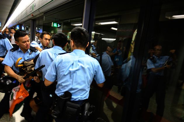 TOPSHOT - A man is arrested at the Lok Fu MTR station during a train disruption protest in Hong Kong on September 2, 2019. - Hong Kong pro-democracy protesters threw morning rush hour train travel into chaos on September 2, kicking off another day of potential turmoil after a weekend featuring some of the worst violence in three months of anti-government protests. (Photo by Philip FONG / AFP)        (Photo credit should read PHILIP FONG/AFP/Getty Images)