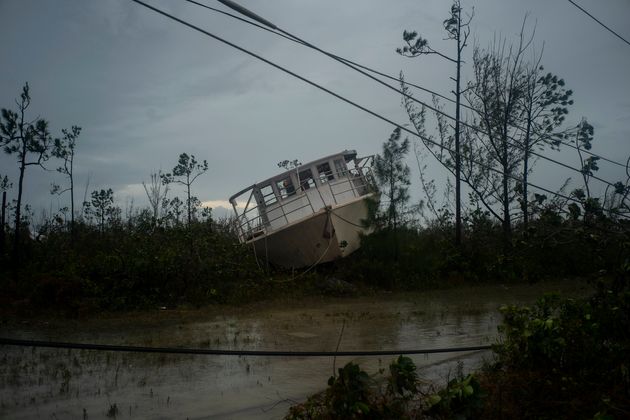 A boat thrown onshore by the Hurricane Dorian lays stranded next to a highway near Freeport, Grand Bahama, Bahamas, Tuesday Sept. 3, 2019. Relief officials reported scenes of utter ruin in parts of the Bahamas and rushed to deal with an unfolding humanitarian crisis in the wake of Hurricane Dorian, the most powerful storm on record ever to hit the islands. (AP Photo/Ramon Espinosa)