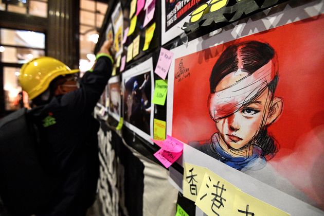 Sticky-notes carrying messages of support for Hong Kong's pro-democracy protesters and an image of a woman who suffered an eye injury, which demonstrators have blamed on a bean-bag round fired by police, are displayed during a demonstration at Martin Place in Sydney on August 16, 2019. - Protests in Hong Kong were sparked by broad opposition to a plan to allow extraditions to mainland China, but has since morphed into a wider call for democratic rights in the semi-autonomous city. (Photo by Saeed KHAN / AFP)        (Photo credit should read SAEED KHAN/AFP/Getty Images)