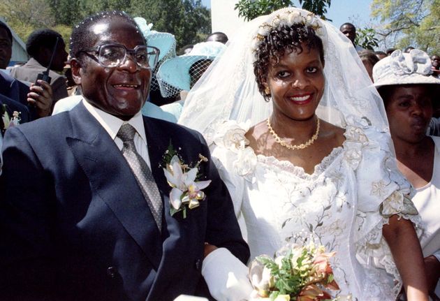 President Robert Mugabe and new wife Grace leave the Kutama Catholic Church August 17, 1996 after exchaning their wedding vows. The couple were traditionally married shortly after the death of Mugabe's first wife Sally. The ceremony was attended by six thousand invited guests.  REUTERS/Howard Burditt