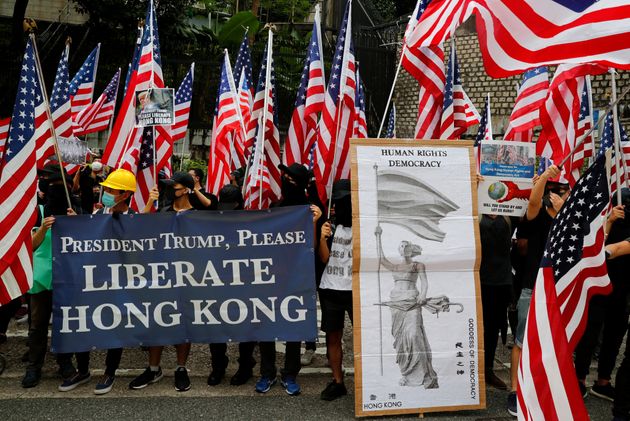 Protesters hold signs and U.S. flags during a rally in Hong Kong, China September 8, 2019. REUTERS/Anushree Fadnavis