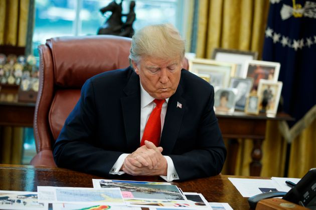 President Donald Trump looks at his notes during a briefing on Hurricane Dorian in the Oval Office of the White House, Wednesday, Sept. 4, 2019, in Washington. (AP Photo/Evan Vucci)