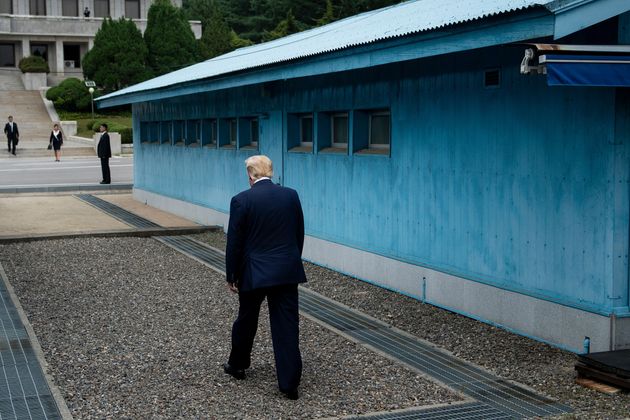US President Donald Trump walks to the line of demarcation to meet North Korea's leader Kim Jong-un in the Demilitarized Zone(DMZ) on June 30, 2019. (Photo by Brendan Smialowski / AFP)        (Photo credit should read BRENDAN SMIALOWSKI/AFP/Getty Images)