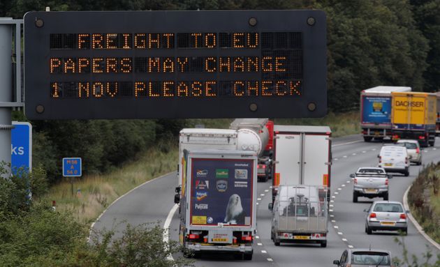 Vehicles pass beneath a sign warning of possible changes to freight procedures following Brexit on the M56 motorway near Chester, Britain, September 12, 2019. REUTERS/Phil Noble