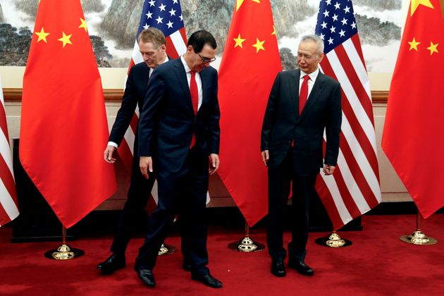 Chinese Vice Premier Liu He, right, looks as U.S. Treasury Secretary Steven Mnuchin, center, changes places with his Trade Representative Robert Lighthizer during a photograph session before they proceed to their meeting at the Diaoyutai State Guesthouse in Beijing, Wednesday, May 1, 2019. (AP Photo/Andy Wong, Pool)