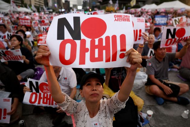 SEOUL, SOUTH KOREA - AUGUST 15: South Koreans hold up signs denouncing Japanese Prime Minister Shinzo Abe during a rally to mark the 74th National Liberation Day on August 15, 2019 in Seoul, South Korea. The bilateral relationship between Japan and South Korea has worsened recently, with the Japanese government's decision to remove South Korea from so-called 'white list' of trade restriction. South Korea marked its 74th National Liberation Day today, which celebrates its independence from Japanese colonial rule following the end of World War II after Japan surrendered between August 14 and 15 in 1945. (Photo by Chung Sung-Jun/Getty Images)