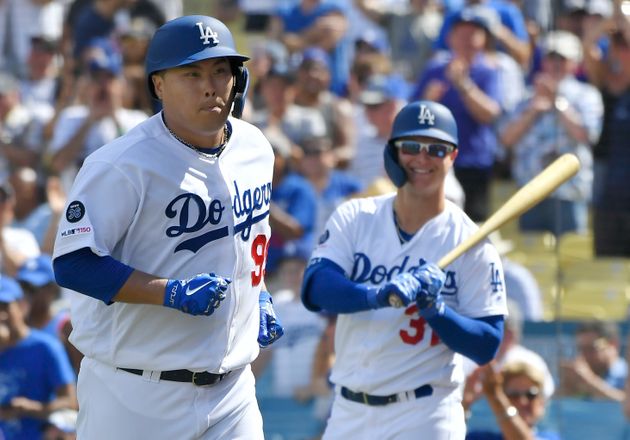 LOS ANGELES, CA - SEPTEMBER 22: Joc Pederson #31 of the Los Angeles Dodgers smiles as Hyun-Jin Ryu #99 runs to the dugout after Ryu hits the first home run of his career in the fifth inning against the Colorado Rockies at Dodger Stadium on September 22, 2019 in Los Angeles, California. (Photo by John McCoy/Getty Images)