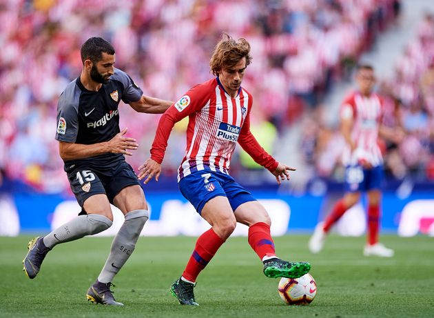 MADRID, SPAIN - MAY 12: Antoine Griezmann of Club Atletico de Madrid competes for the ball with Maxime Gonalons of Sevilla FC de Madrid during the La Liga match between  Club Atletico de Madrid and Sevilla FC at Wanda Metropolitano on May 12, 2019 in Madrid, Spain. (Photo by Quality Sport Images/Getty Images)