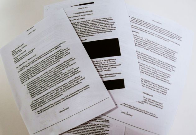 Photo illustration on September 26, 2019 shows redacted pages of the whistleblower complaint referring to US President Donald Trump's call with his Ukrainian counterpart Volodymyr Zelensky. - Trump solicited interference from Ukraine to influence the 2020 US elections, and the White House intervened to 'lock down' the transcript of the call, the whistleblower said in a complaint released Thursday. 'I have received information from multiple US government officials that the president of the United States is using the power of his office to solicit interference from a foreign country in the 2020 US election,' the whistleblower, an unidentified intelligence community official, wrote in the complaint released by Congress. The whistleblower said White House officials had expressed alarm about the gravity of Trump's call with his Ukrainian counterpart, and that they told the whistleblower that they had likely 'witnessed the president abuse his office for personal gain.' (Photo by EVA HAMBACH / AFP)        (Photo credit should read EVA HAMBACH/AFP/Getty Images)