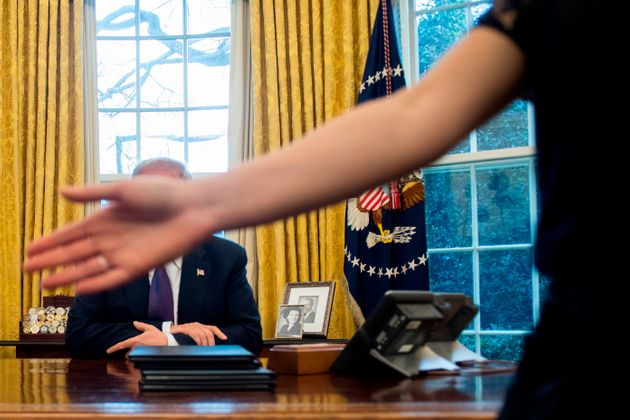 A White House staff member calls for no more questions after US President Donald Trump (L) signed Section 201 actions to impose tariffs in the Oval Office of the White House in Washington, DC, on January 23, 2018. / AFP PHOTO / JIM WATSON        (Photo credit should read JIM WATSON/AFP/Getty Images)