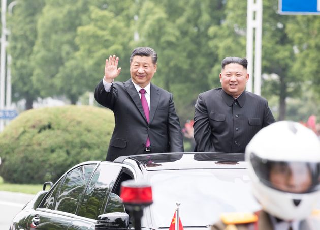 PYONGYANG, June 20, 2019 -- General Secretary of the Central Committee of the Communist Party of China and Chinese President Xi Jinping and Kim Jong Un, chairman of the Workers' Party of Korea and chairman of the State Affairs Commission of the Democratic People's Republic of Korea, ride an open-top vehicle to the square of the Kumsusan Palace of the Sun amid welcoming crowds, following a grand welcoming ceremony held by the DPRK side at the Sunan International Airport, in Pyongyang, DPRK, June 20, 2019. Xi Jinping arrived here Thursday for a state visit to the DPRK. Xi and his wife, Peng Liyuan, were greeted beside the ramp by Kim Jong Un and his wife, Ri Sol Ju. (Photo by Huang Jingwen/Xinhua via Getty) (Xinhua/ via Getty Images)