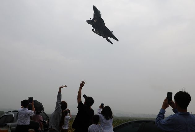 제71주년 국군의 날 기념행사가 1일 오전 대구 공군기지에서 열렸다. 시민들이 기지 밖에서 악천후 속에도 조국의 영공을 수호하는 대한민국 공군의 F-15K 비행 모습을 지켜보며 손을 흔들고 있다.