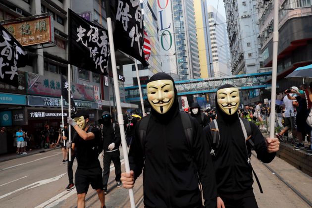 Protesters march wearing Guy Fawkes masks, which has come to represent anti-government protests around the world, during a protest in Hong Kong on Sunday, Sept. 29, 2019. Sunday's gathering of protesters, a continuation of monthslong protests for greater democracy, is part of global 'anti-totalitarianism' rallies planned in over 60 cities worldwide to denounce 'Chinese tyranny.' (AP Photo/Kin Cheung)