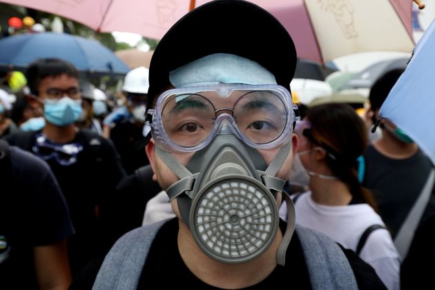A protester wears a gas mask in case of a tear gas in front of a police headquarter in Hong Kong, China June 21, 2019. REUTERS/Ann Wang