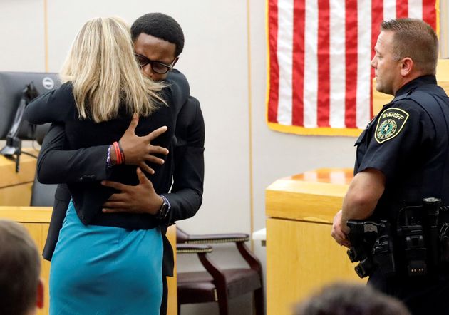 Botham Jean's younger brother Brandt Jean hugs former Dallas police officer Amber Guyger after delivering his impact statement to her following her 10-year prison sentence for murder at the Frank Crowley Courts Building in Dallas, Texas, U.S. October 2, 2019.  Tom Fox/Pool via REUTERS MANDATORY CREDIT