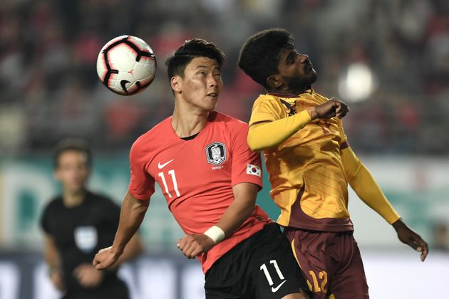 South Korea's Hwang Hee-chan (L) and Sri Lanka's Chalana Chameera (R) fights for the ball during their World Cup 2022 Qualifying Asian zone Group H football match between South Korea and Sri Lanka in Hwaseong on October 10, 2019. (Photo by Jung Yeon-je / AFP) (Photo by JUNG YEON-JE/AFP via Getty Images)