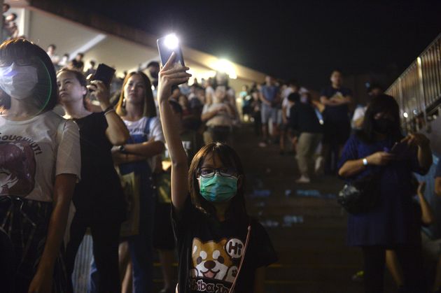 A Girl is seen holding up a candle light in Shueng Shui during a Vigil in Hong Kong on October 9, 2019, Pro-Democracy Protesters have been taken to the street of Hong Kong for Months in Protest of the government, the Protesters have five major demands including setting up an independent inquiry into police misconduct while handling recent protest in Hong Kong. (Photo by Vernon Yuen/NurPhoto via Getty Images)